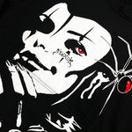 Black hoodie with white gothic face print, red eyes, spider, and stylized text on cheek