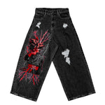 Black distressed jeans with red and black anime character graphic and lightning design on left leg