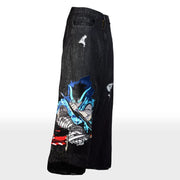 Black denim pants with distressed details and colorful anime character graphic on side